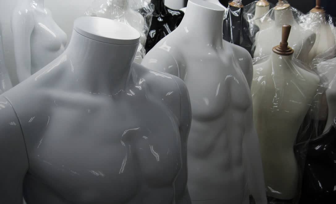 White and black mannequin torsos and dress forms in the showroom